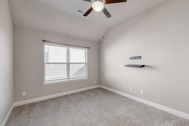 empty room with ceiling fan, lofted ceiling, and carpet