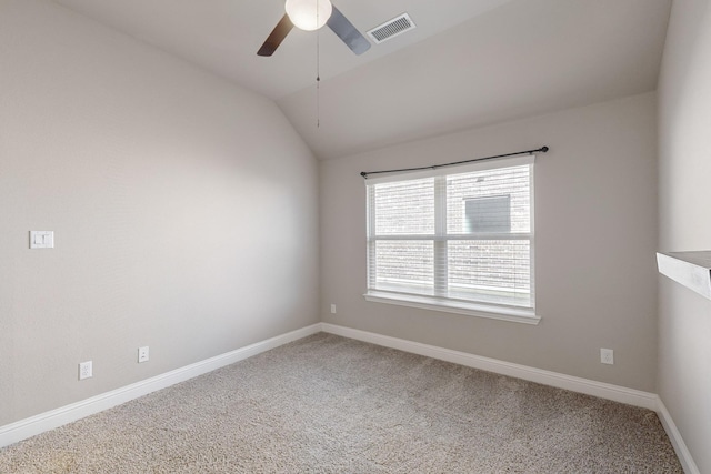 carpeted spare room with ceiling fan and lofted ceiling