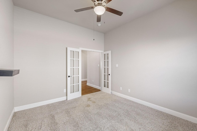 carpeted spare room with french doors and ceiling fan