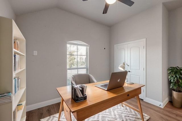 office space featuring ceiling fan, vaulted ceiling, and light hardwood / wood-style flooring