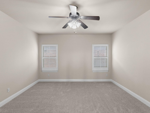 carpeted spare room featuring ceiling fan