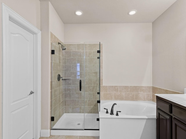 bathroom featuring plus walk in shower and vanity