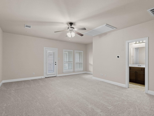 empty room with light carpet, ceiling fan, and sink