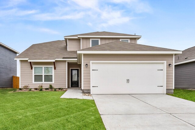 view of front of home featuring a garage and a front lawn