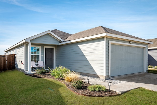 single story home with a garage and a front lawn