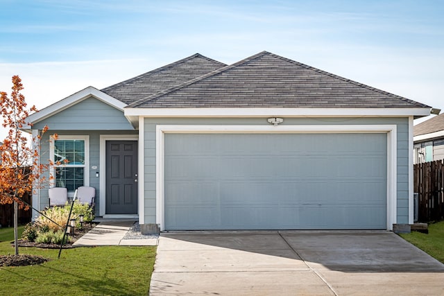 single story home with a front yard and a garage