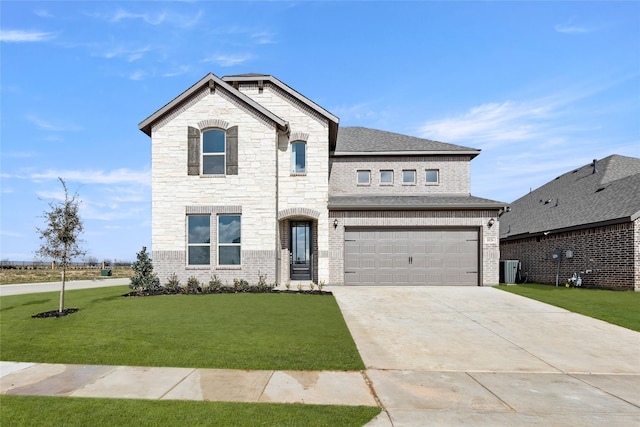 view of front facade featuring a shingled roof, an attached garage, concrete driveway, brick siding, and a front lawn