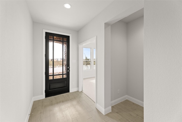 entryway featuring light wood-style flooring, recessed lighting, and baseboards