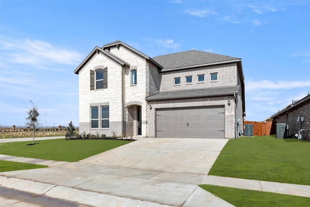 view of front of property with a garage, central air condition unit, and a front lawn