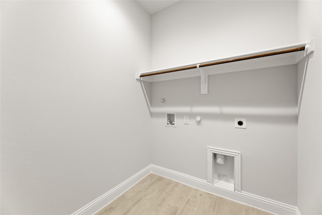 washroom featuring laundry area, light wood-style floors, hookup for a washing machine, hookup for an electric dryer, and hookup for a gas dryer