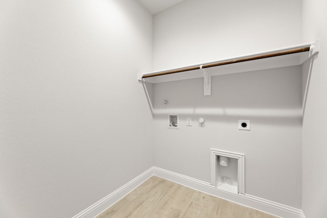 laundry room featuring hookup for an electric dryer, hookup for a gas dryer, light wood-style flooring, laundry area, and hookup for a washing machine