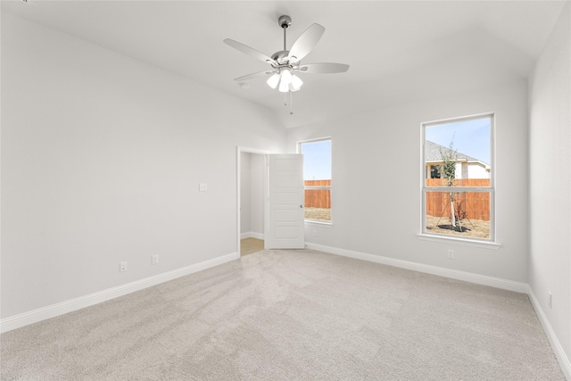 unfurnished room with ceiling fan, light carpet, and baseboards