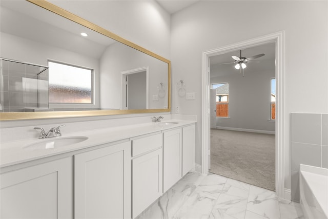 bathroom featuring a sink, a bathing tub, ceiling fan, double vanity, and marble finish floor