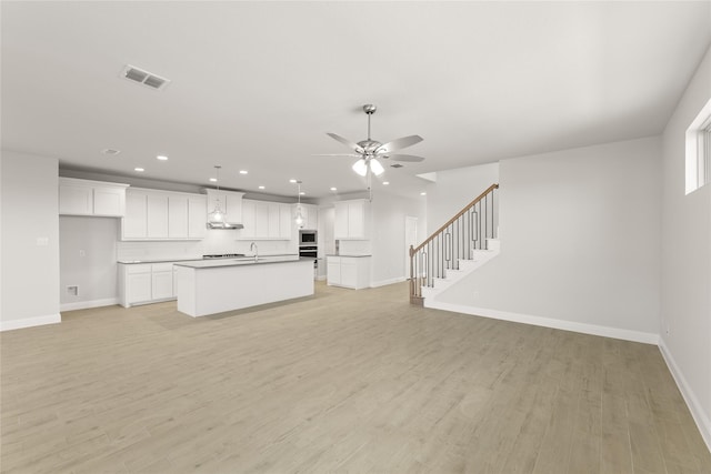 unfurnished living room with visible vents, baseboards, a ceiling fan, light wood-style floors, and recessed lighting