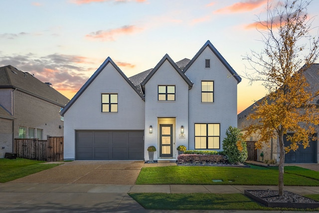 modern inspired farmhouse with a lawn and a garage