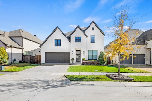 view of front of home with a garage and a front lawn