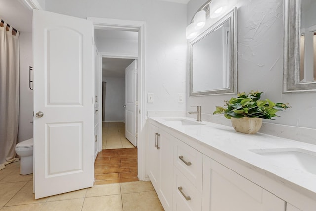 bathroom featuring tile patterned flooring, vanity, and toilet