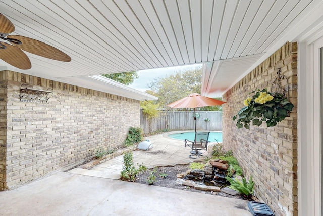 view of patio featuring a fenced in pool and ceiling fan