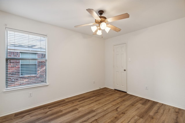 empty room with hardwood / wood-style flooring and ceiling fan