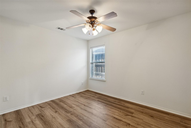 empty room featuring ceiling fan and hardwood / wood-style floors