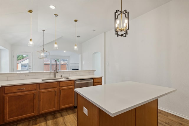 kitchen featuring wood-type flooring, a kitchen island, pendant lighting, and sink