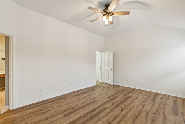 empty room with hardwood / wood-style floors, ceiling fan, and lofted ceiling