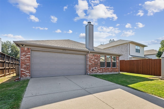 view of front of home featuring a front lawn and a garage