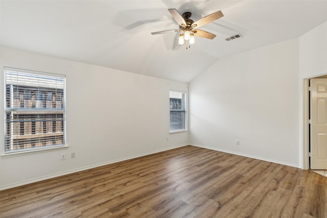 unfurnished room with hardwood / wood-style flooring, ceiling fan, lofted ceiling, and a wealth of natural light