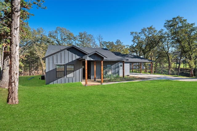 view of front facade with a front yard and a carport