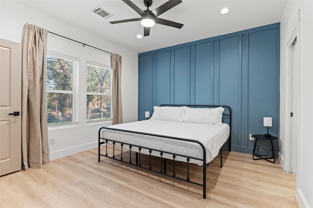 bedroom with light hardwood / wood-style flooring and ceiling fan