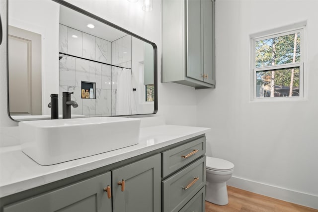 bathroom featuring a shower with curtain, hardwood / wood-style floors, vanity, and toilet