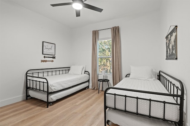 bedroom with light hardwood / wood-style floors and ceiling fan