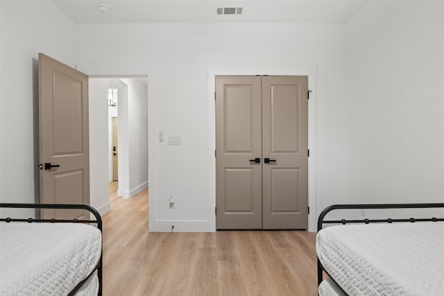 bedroom featuring light hardwood / wood-style floors and a closet