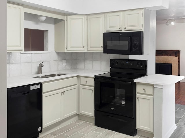 2649 Peavy Rd, Dallas, TX 75228 - kitchen featuring black appliances, light countertops, wood tiled floors, decorative backsplash, and track lighting