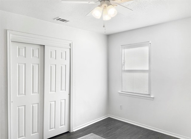 2649 Peavy Rd, Dallas, TX 75228 - unfurnished bedroom with dark wood-style floors, a closet, a textured ceiling, and ceiling fan
