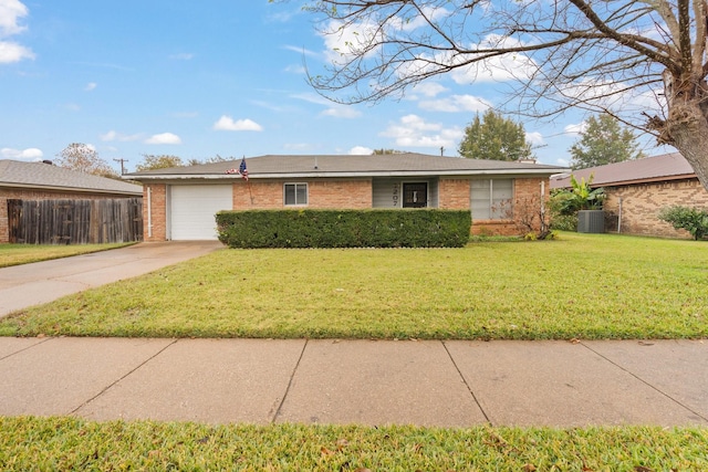 single story home with cooling unit, a garage, and a front lawn