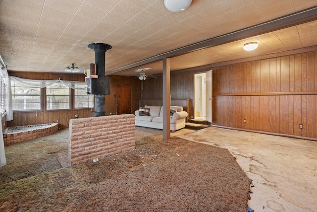 unfurnished living room featuring wood walls