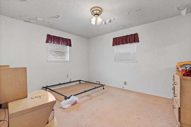 carpeted bedroom featuring a textured ceiling