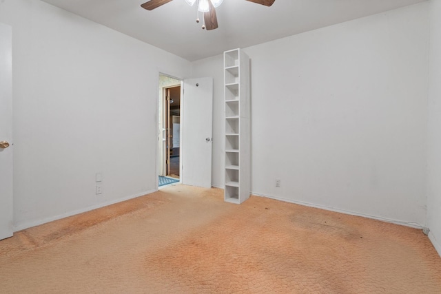 unfurnished room with carpet flooring and ceiling fan