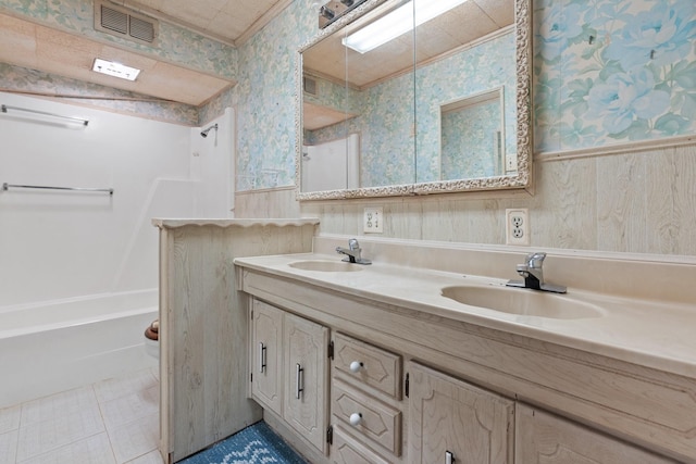 bathroom with washtub / shower combination, vanity, tile patterned floors, and ornamental molding