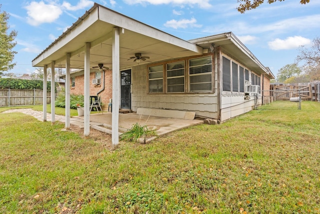 rear view of house with a lawn, ceiling fan, cooling unit, and a patio