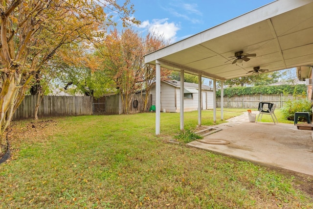 view of yard featuring ceiling fan and a patio area