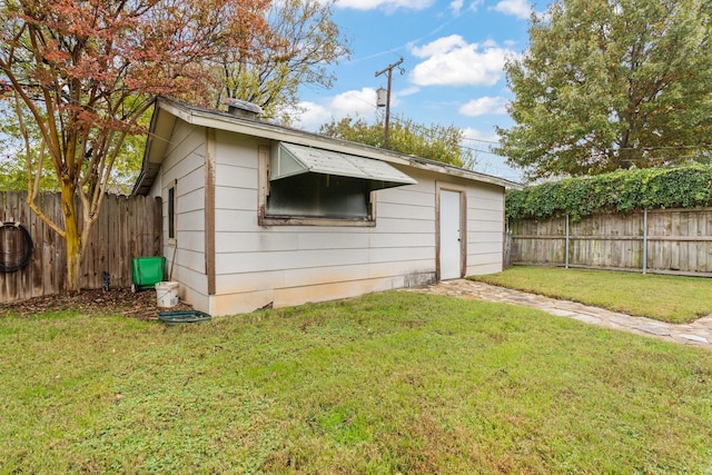 view of outbuilding with a lawn