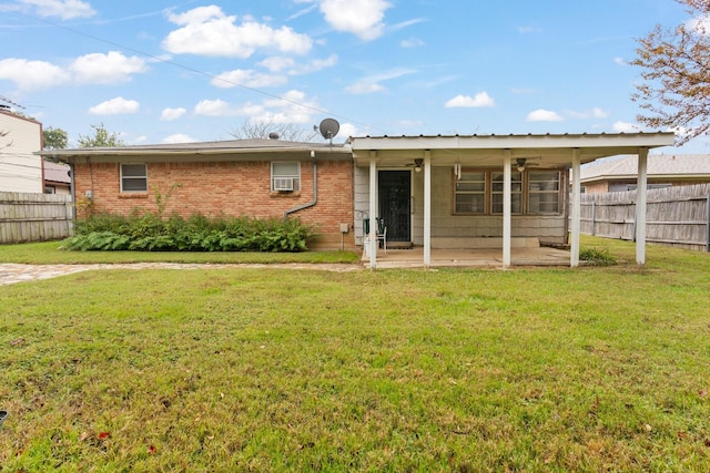 rear view of property featuring a yard, a patio, and cooling unit