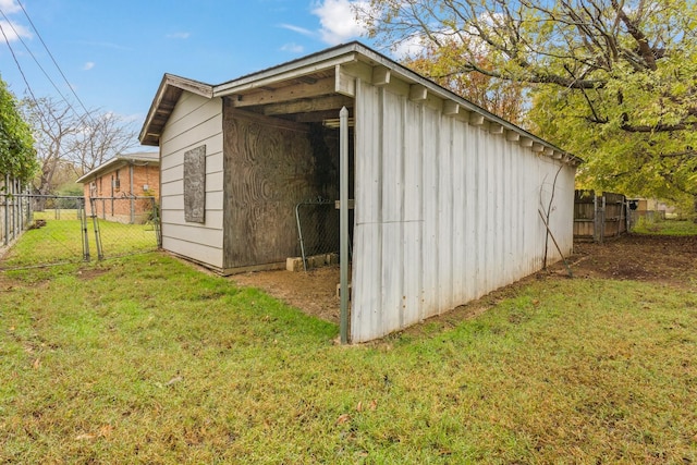 view of outbuilding featuring a lawn