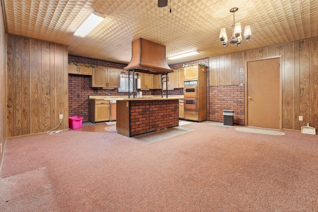 kitchen with light carpet, a kitchen island, and wood walls