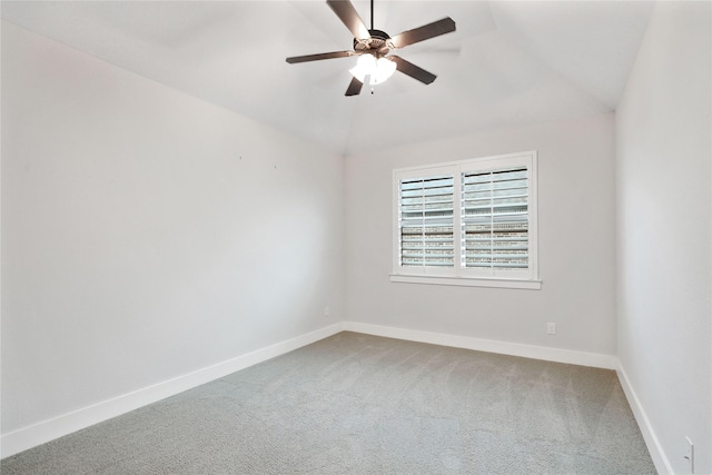 spare room featuring carpet floors, vaulted ceiling, and ceiling fan