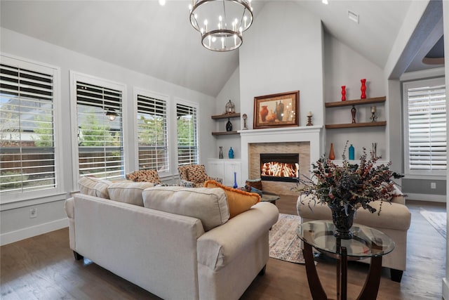 living room with dark hardwood / wood-style floors, an inviting chandelier, and high vaulted ceiling