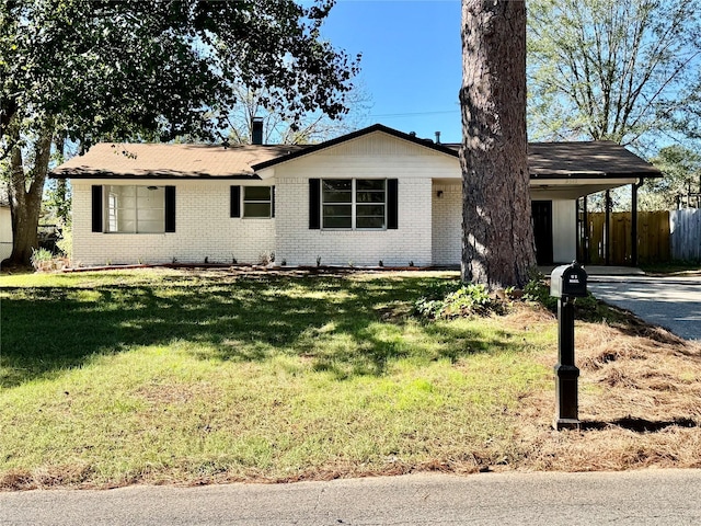 ranch-style home with a front lawn and a carport