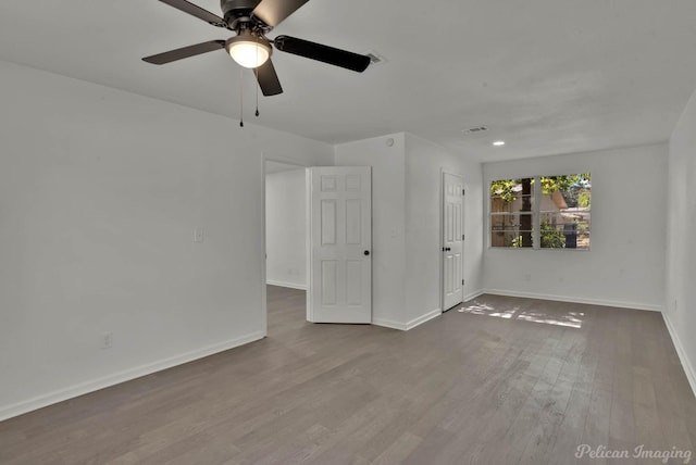 spare room with hardwood / wood-style floors and ceiling fan